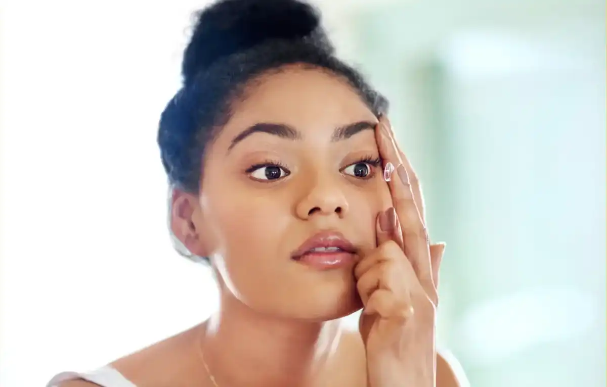 Patient placing a contact lens during a fitting in South Ogden, Utah